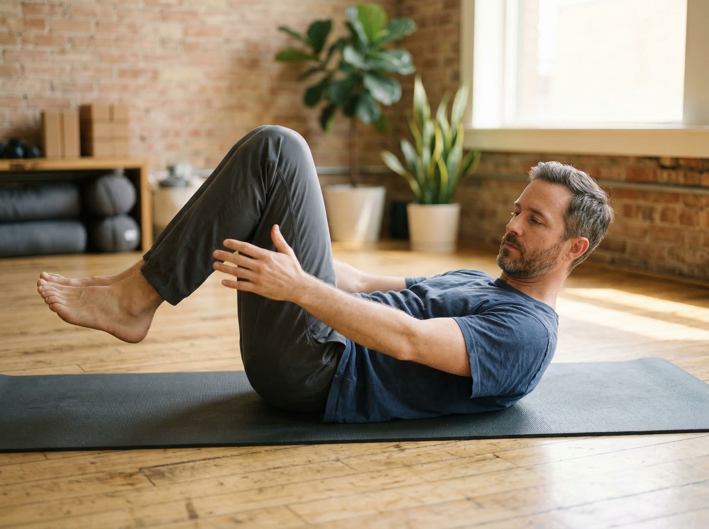Man performing targeted pelvic floor exercises on a gym mat, focused and deliberate — representing male pelvic health training