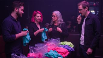 Men and women at a pheromone party smelling T-shirts and meeting through scent-based matchmaking.