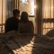 Silhouettes of a couple sitting close together in morning light, representing honesty and emotional connection.